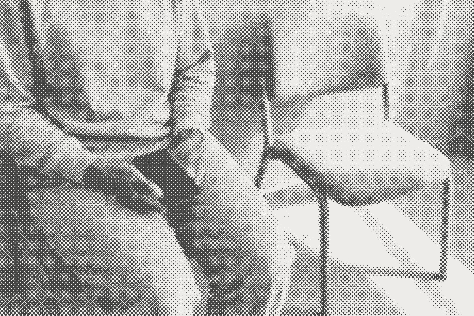 A halftone print of a person waiting with a phone in their hands and an empty chair beside them.